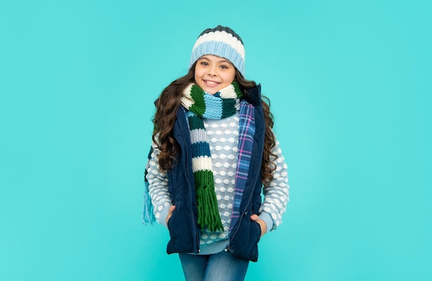 Portrait of child wearing warm clothes express positive emotion winter fashion