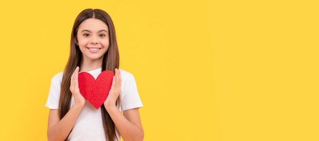 Portrait of child with heart happy valentines day be my\
valentine teen girl kid girl portrait with heart love symbol\
horizontal poster banner header with copy space