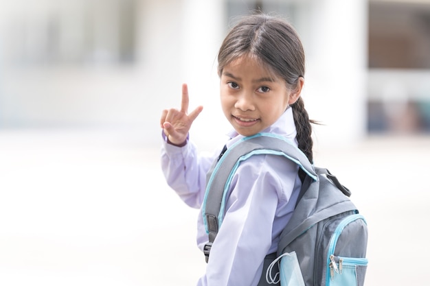 Portrait of children student in uniform and backpack Looking at camera going back to school after covid-19 quarantine and lockdown. Back to School Concept Stock Photo