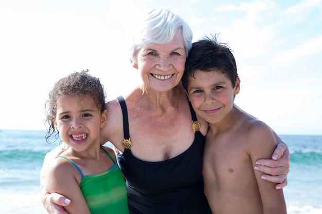 Ritratto di bambini con la nonna in spiaggia