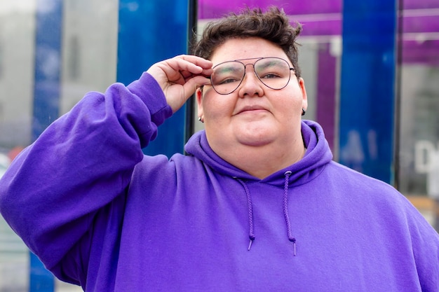 Portrait of a chubby woman wearing glasses in the street