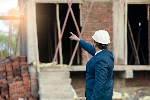 Portrait of civil engineer with safety uniform working at construction site