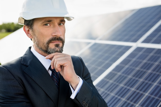 Ritratto del cliente in casco bianco alla centrale elettrica solare.