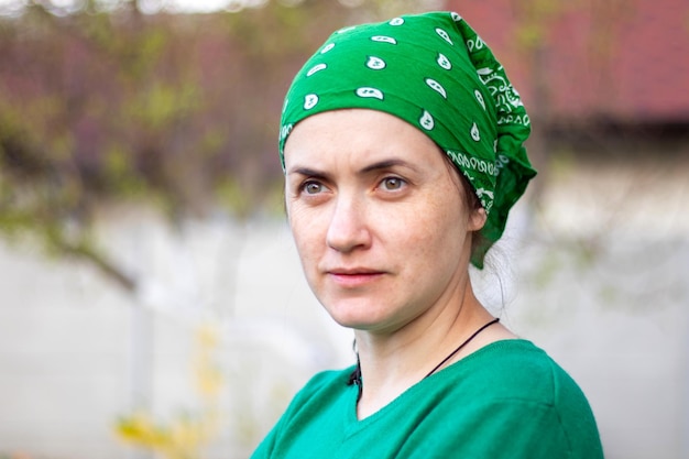 Portrait closeup Beautiful young woman without makeup in green tshirt and green sun hat on a sunny