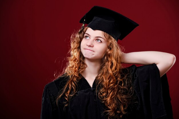 Portrait closeup. European beautiful smiley graduate graduated student girl young woman in cap