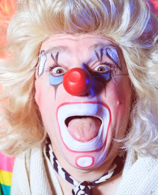 Photo portrait of a clown in the circus arena.