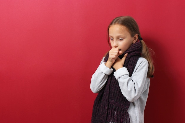 Portrait of a cold girl on a colored background