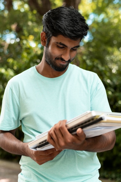 Portrait of college student holding some books