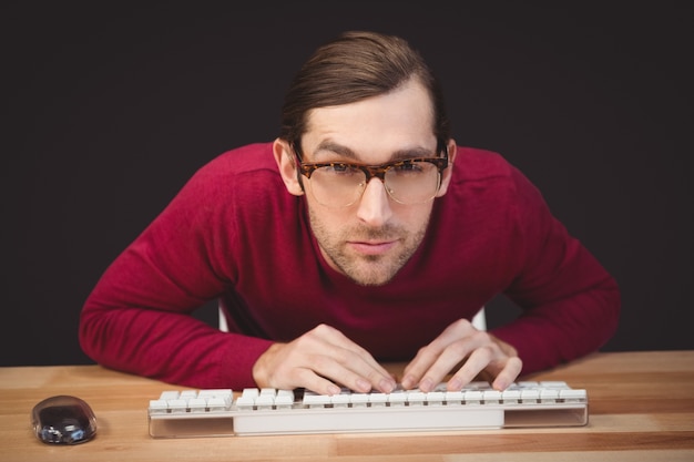 Portrait of concentrated man working on computer