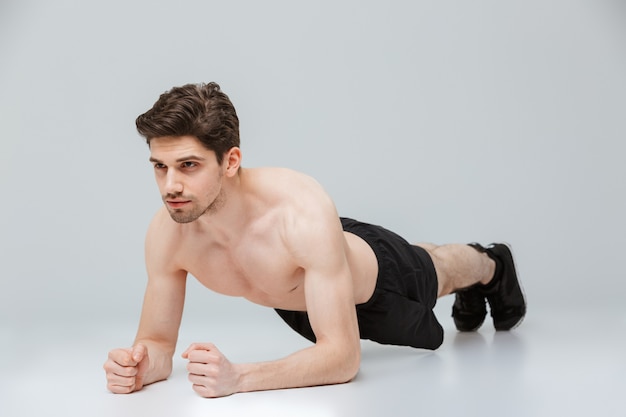 Portrait of a concentrated young half naked sportsman