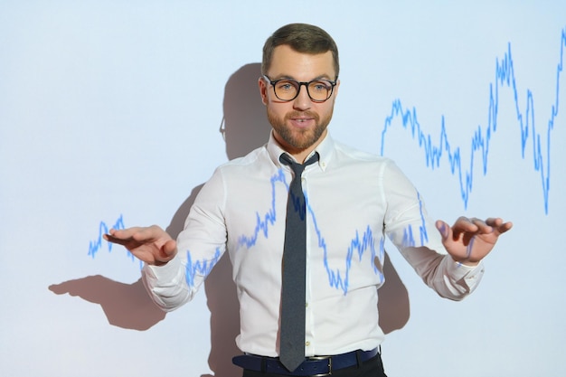 Portrait of concerned European businessman thinking in blurry office with double exposure of falling financial chart Concept of crisis and stock market