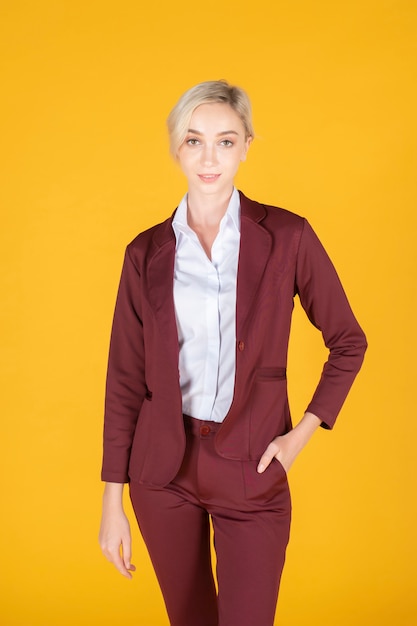 Portrait of confidence caucasian business woman on yellow background 