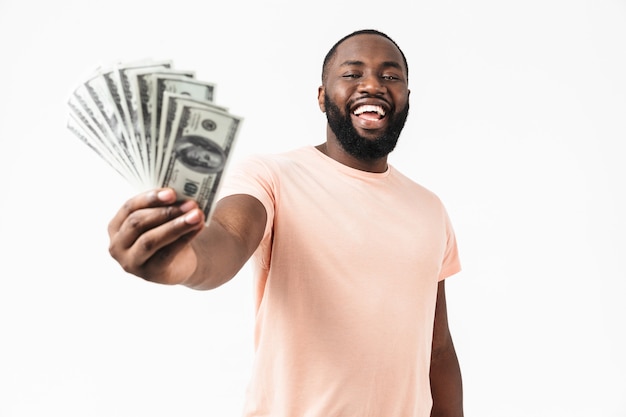 Portrait of a confident african man wearing shirt standing isolated, showing money banknotes