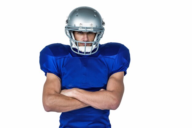 Portrait confident of American football player with arms crossed