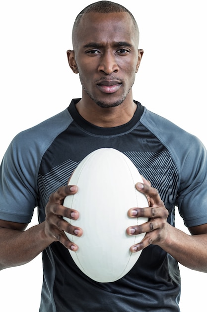 Portrait of confident athlete holding rugby ball