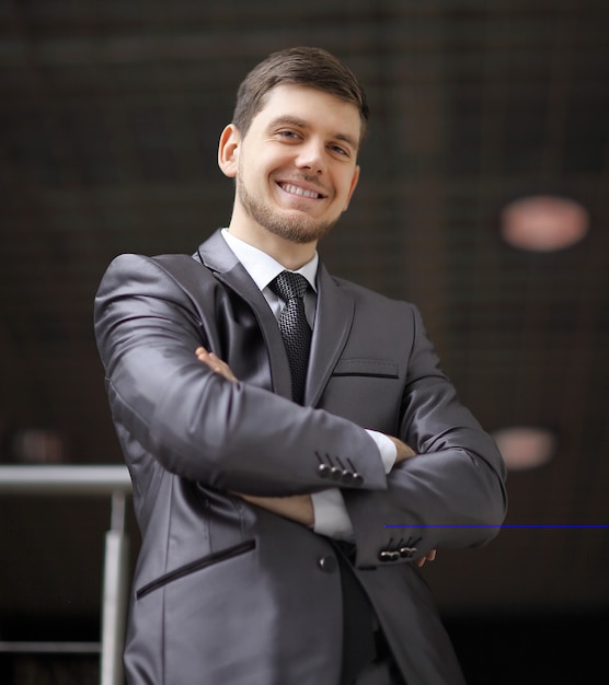 Portrait of confident businessman on background of office.photo with copy space