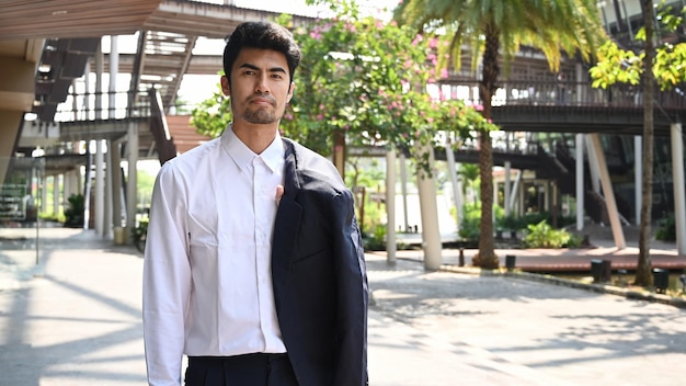 Portrait of confident businessman standing outdoors near office building