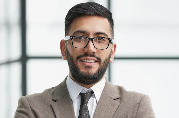 Portrait of confident businessman with arms crossed in office