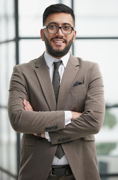 Portrait of confident businessman with arms crossed in office