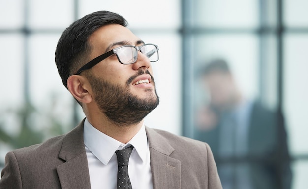 Portrait of confident businessman with arms crossed in office