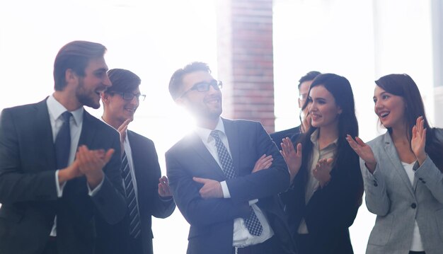 Portrait of confident colleagues congratulating each other on v