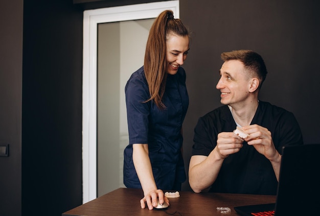 Portrait of confident dentist and assistant in office