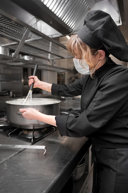 Portrait of confident female chef working in commercial kitchen