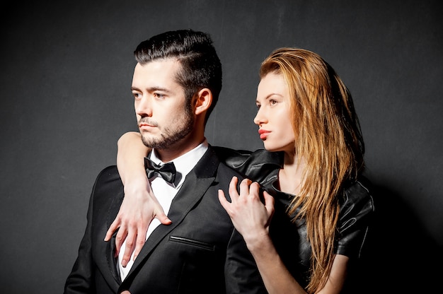 Portrait of confident handsome man in black suit. Bearded young man blonde model