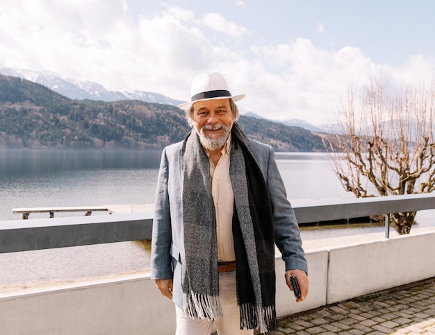 Portrait of a confident handsome mature man pensioner grandfather in the small town