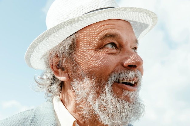 Portrait of a confident handsome mature man pensioner grandfather in the small town