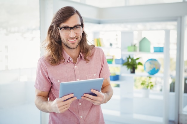 Portrait of confident hipster holding digital tablet