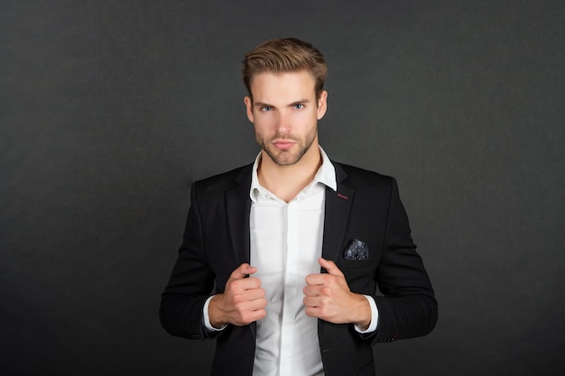 Portrait of confident manager office worker on black background