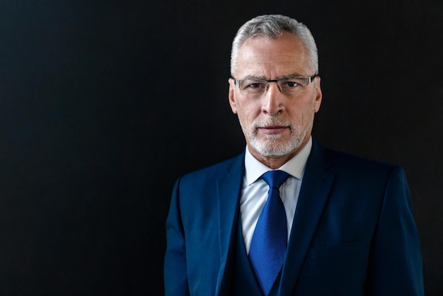 Portrait of confident mature businessman wearing suit and necktie