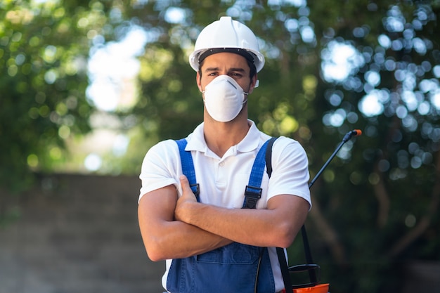 Portrait of confident pesticide worker with arms crossed