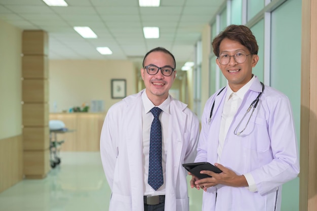 Portrait of confident smiling doctor wearing white coat in hospital