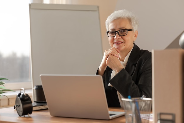 Portrait of confident stylish european middle aged senior woman at workplace stylish older mature s