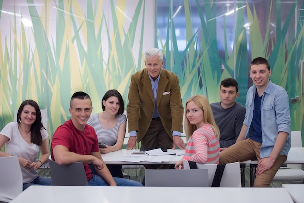 portrait of confident teacher,  students group in background