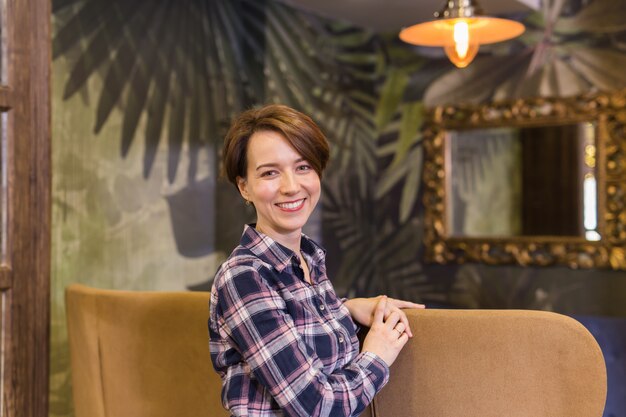 Portrait of confident woman smiling in cafe