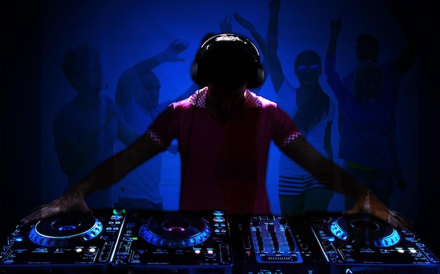 Photo portrait of confident young dj with headphones on head mixing music on mixer