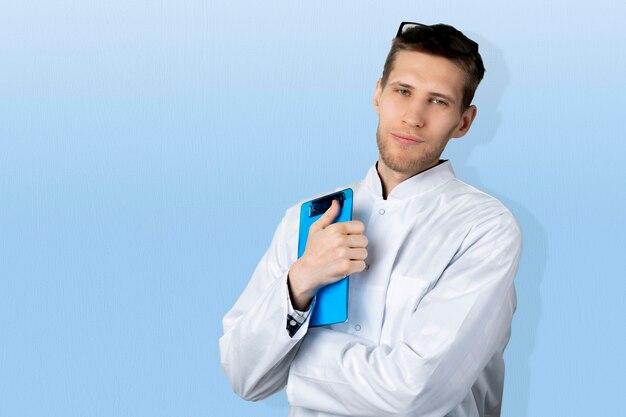 A portrait of a confident young male doctor in white medical uniform