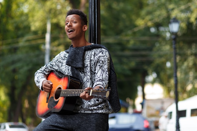 Portrait of a confident young man playing guitar