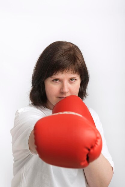 Portrait of confident young woman in boxing gloves Woman fights for justice Feminism Vertical frame