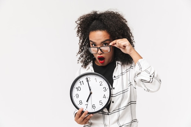 Portrait of a confused african woman standing isolated over white background