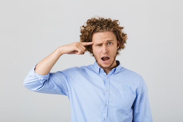 Portrait of a confused young man with curly hair