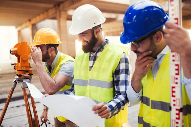 Portrait of construction engineers working on building site together