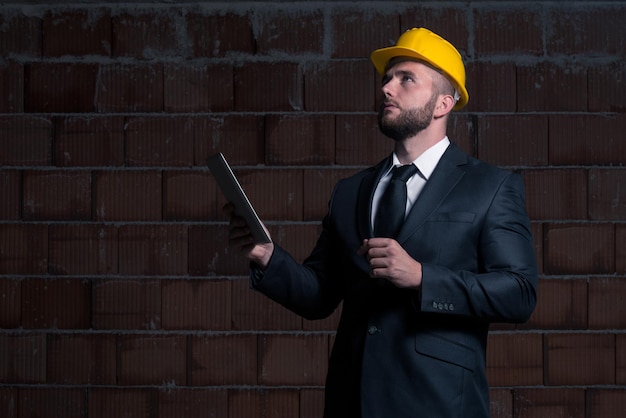 Portrait Of Construction Master With Personal Computer In Hands