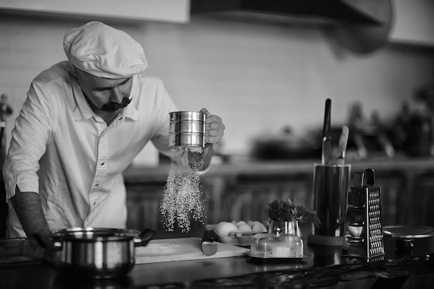 portrait of a cook, mustachioed male chef in a hat, profession