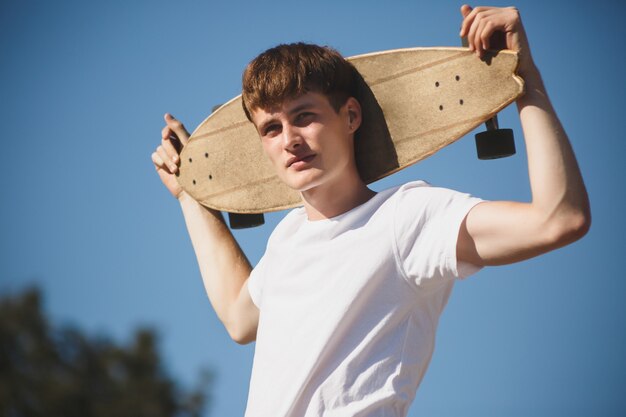 Portrait of a cool boy with a skateboard