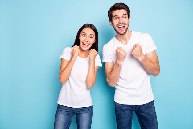 Portrait of couple celebrating raise fist open mouth