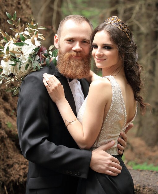 Portrait of a couple in love on a forest background.